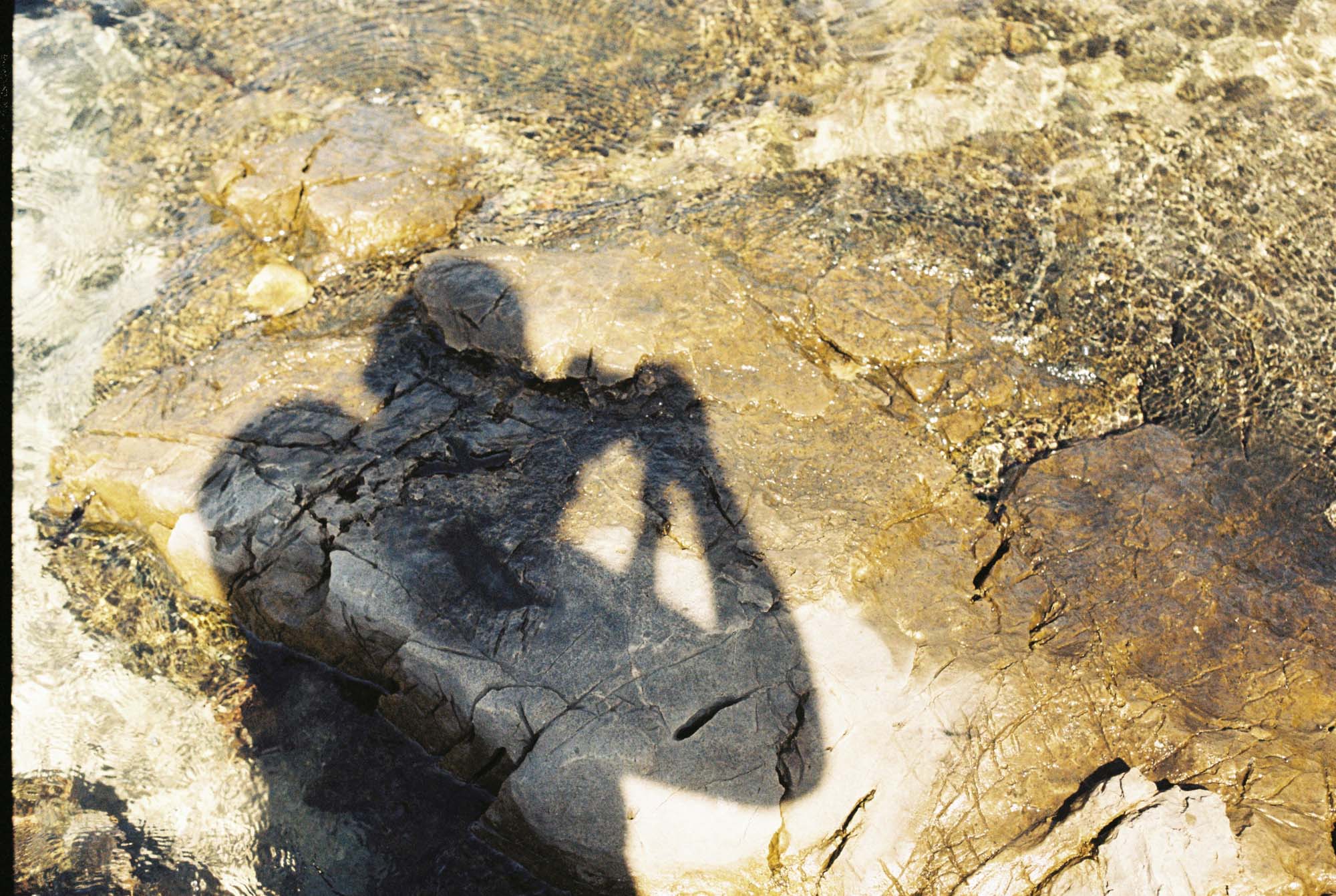 The shadow of a photographer on rocks